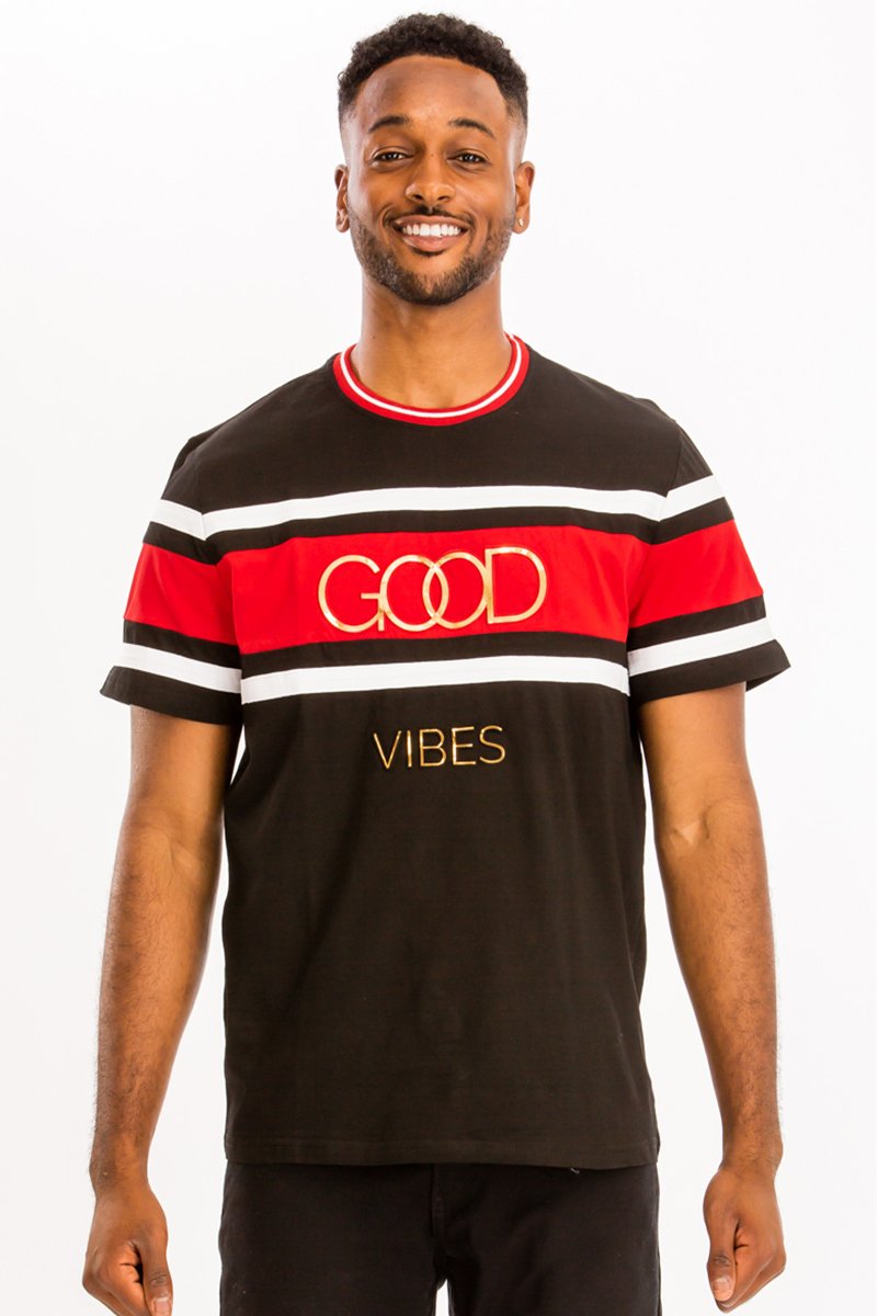 A model wearing the GOOD VIBES TEE, showcasing its relaxed fit and soft cotton fabric in a casual setting.