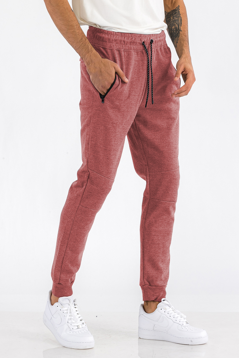 Heathered cotton sweats featuring an elastic waist, ankle cuffs, and a zipper pocket, perfect for casual wear.