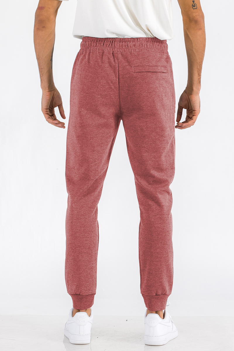 Heathered cotton sweats featuring an elastic waist, ankle cuffs, and a zipper pocket, perfect for casual wear.