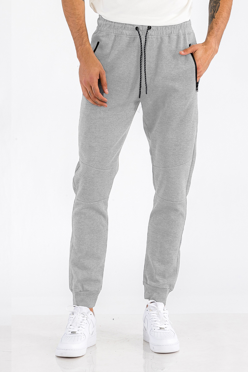 Heathered cotton sweats featuring zippered pockets and elastic waist with drawstring, perfect for casual wear.