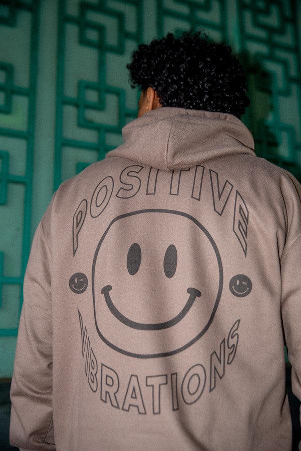 Heavyweight mocha hoodie featuring a vibrant 90s rave smiley print, showcasing its stylish design and quality fabric.