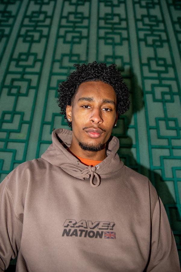 Heavyweight mocha hoodie featuring a vibrant 90s rave smiley print, showcasing its stylish design and quality fabric.