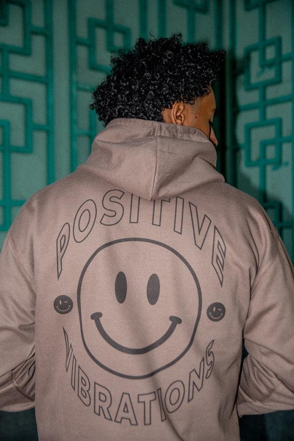 Heavyweight mocha hoodie featuring a vibrant 90s rave smiley print, showcasing its stylish design and quality fabric.