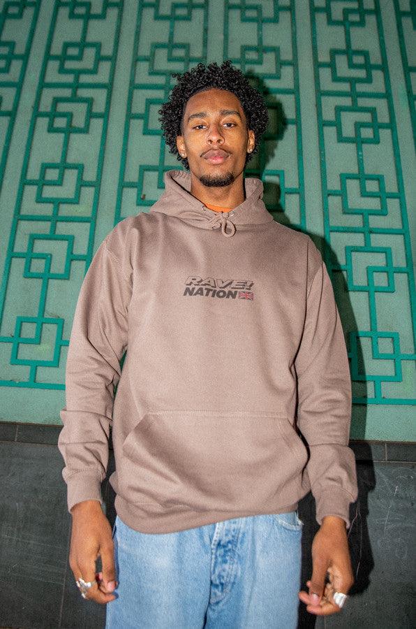 Heavyweight mocha hoodie featuring a vibrant 90s rave smiley print, showcasing its stylish design and quality fabric.