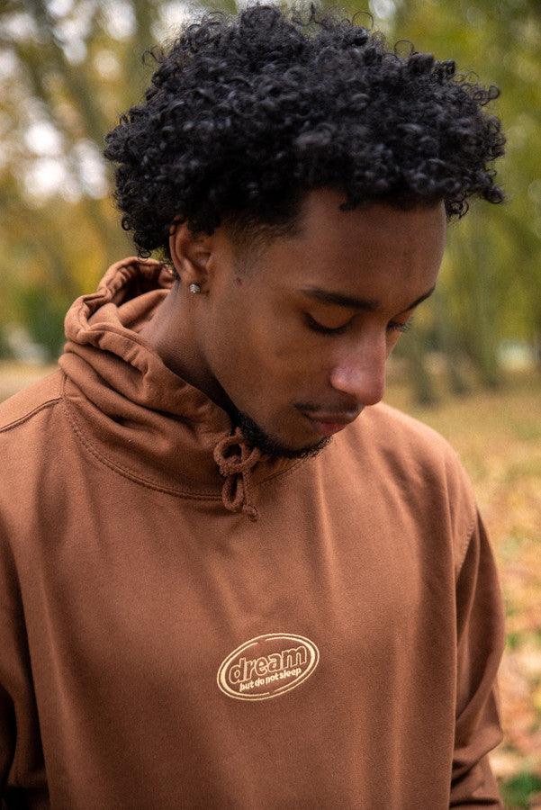 Caramel Toffee Hoodie featuring oval logo embroidery, showcasing its stylish design and heavyweight cotton material.