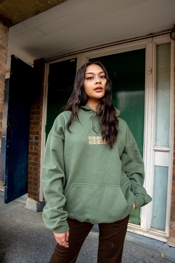 Military green unisex hoodie featuring repeat embroidery logo design in the center, showcasing a relaxed fit and soft fabric.