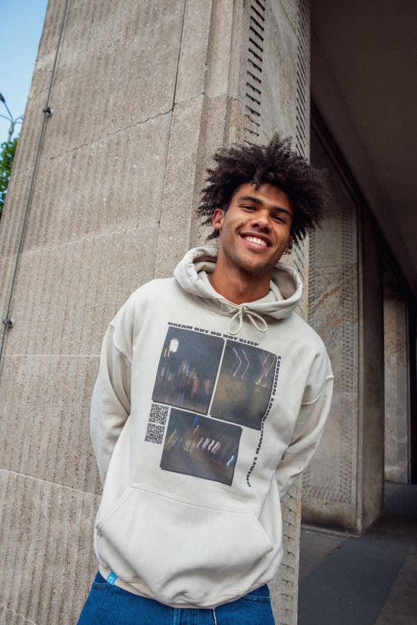 A stylish sand-colored hoodie featuring a ghost town print, perfect for summer wear.