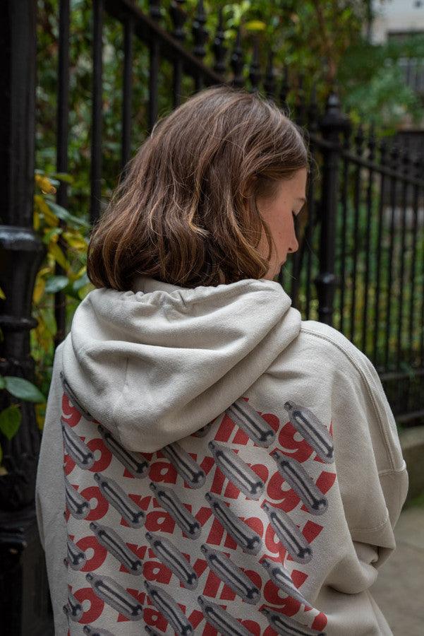 Sand hoodie featuring Go Raving! print on the front and graphic design on the back, showcasing relaxed fit and stylish details.