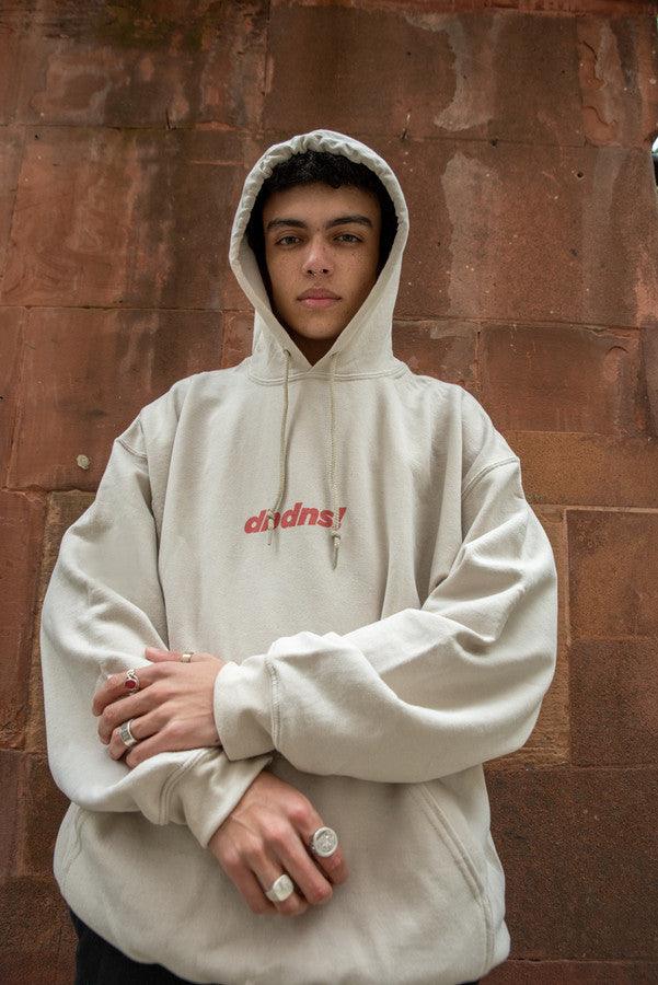 Sand hoodie featuring Go Raving! print on the front and graphic design on the back, showcasing relaxed fit and stylish details.