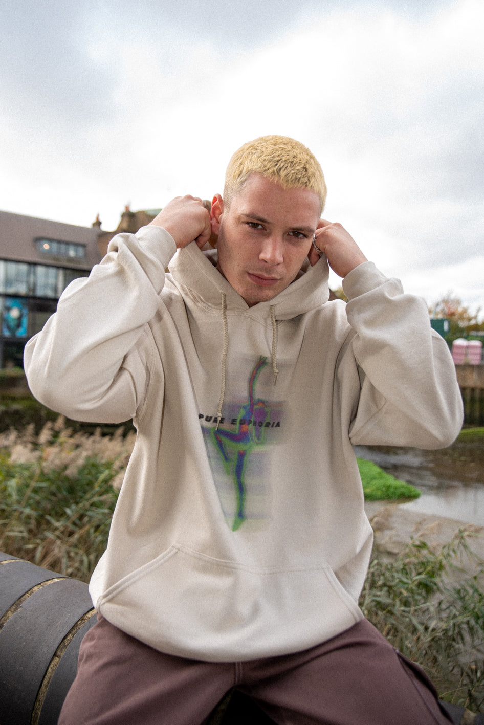 A stylish unisex sand hoodie featuring a vibrant Pure Euphoria print, showcasing its relaxed fit and heavyweight cotton material.