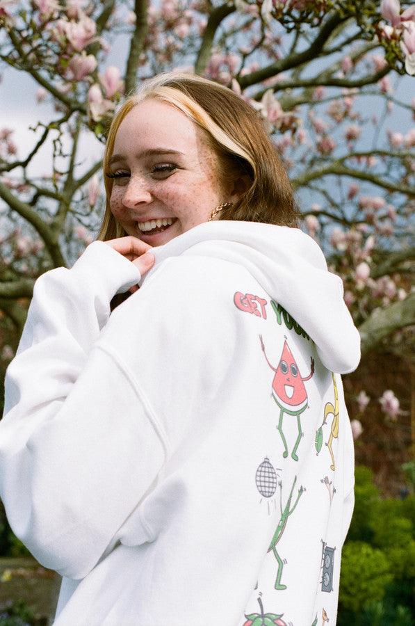 White hoodie featuring a colorful Fruity Ravers print with playful fruit characters, perfect for festival season.