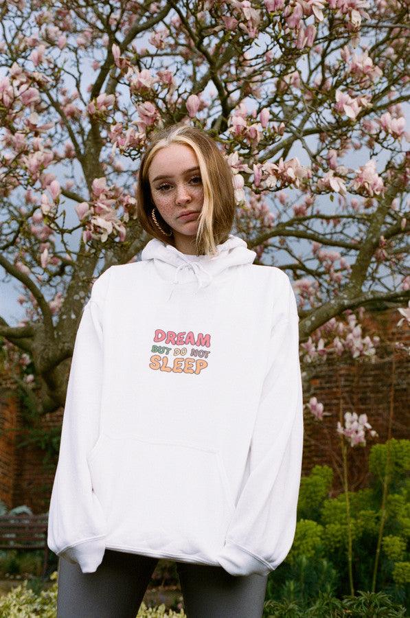 White hoodie featuring a colorful Fruity Ravers print with playful fruit characters, perfect for festival season.