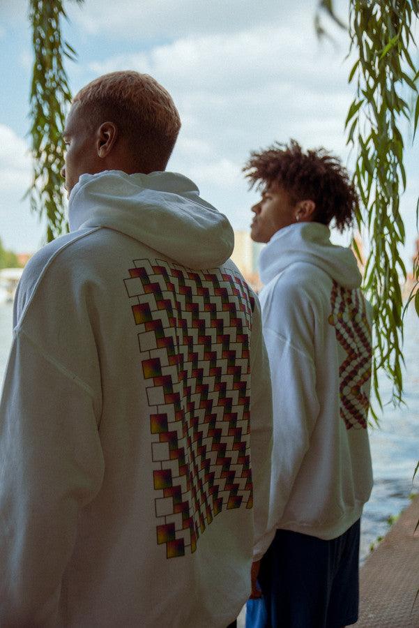 White hoodie featuring a colorful square geometric logo print on the back, showcasing a relaxed fit and soft cotton material.