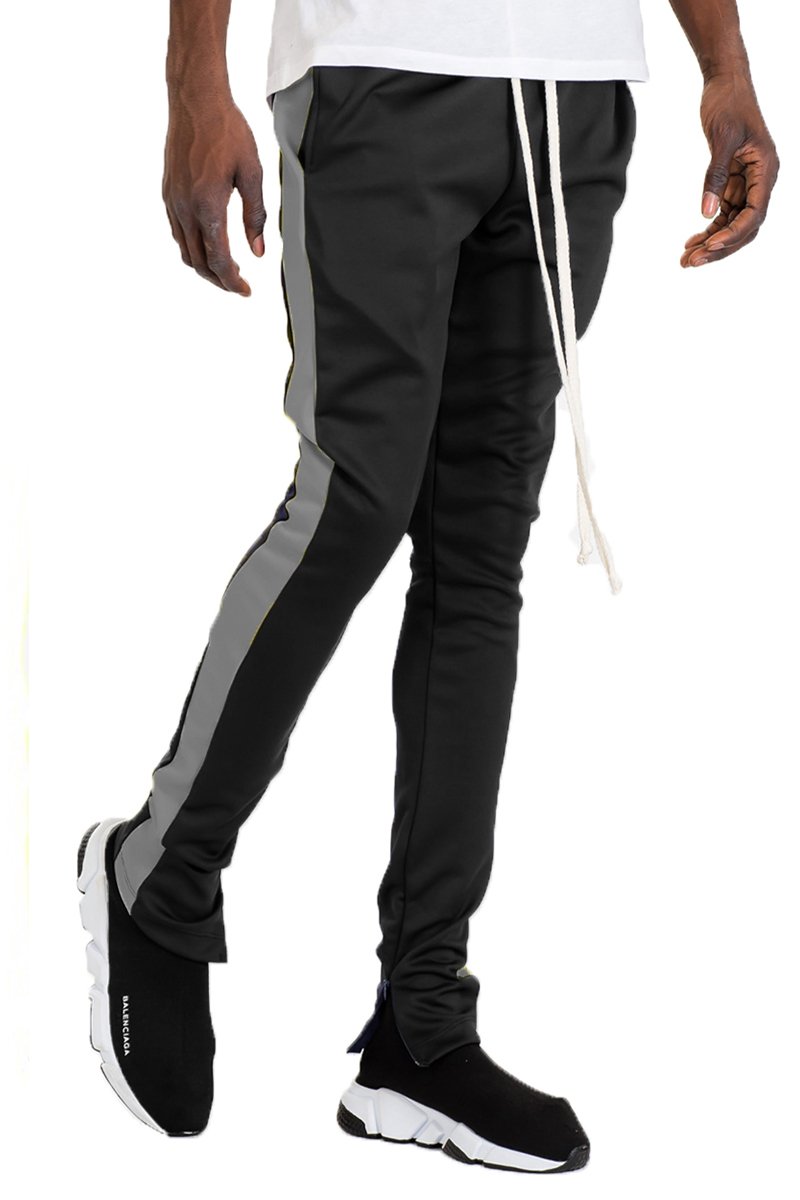 Holiday Track Pants in Black and Grey with a skinny fit, featuring standard pockets and a hidden ankle zipper.