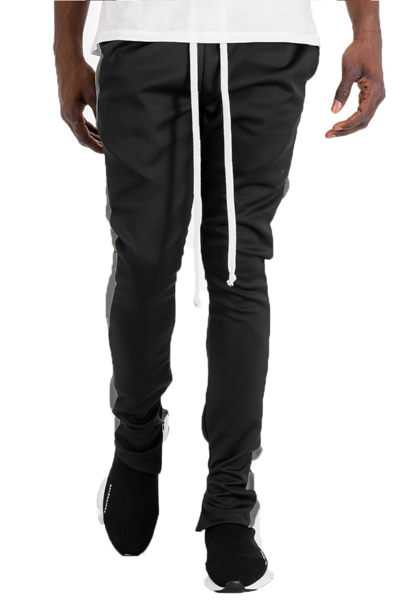 Holiday Track Pants in Black and Grey with a skinny fit, featuring standard pockets and a hidden ankle zipper.