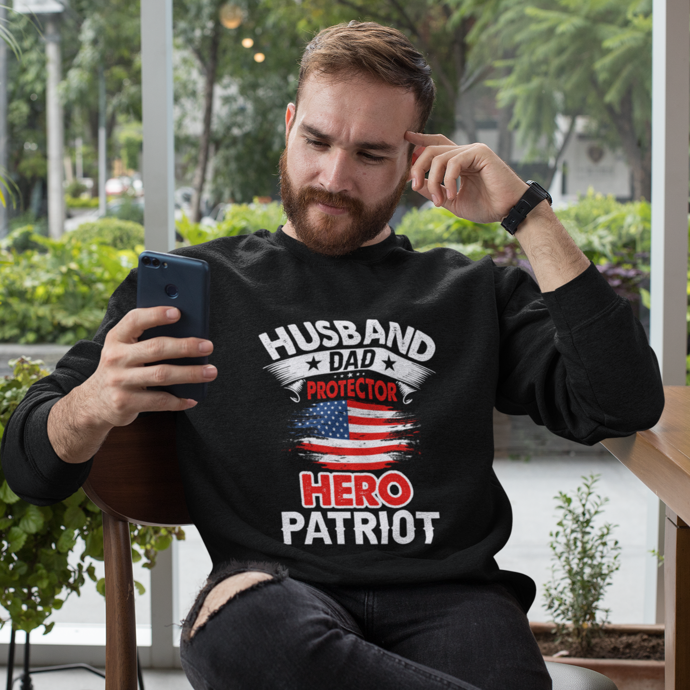 Husband, Dad, Protector, Hero, Patriot Crewneck Sweatshirt displayed on a hanger, showcasing its soft fabric and trendy design.