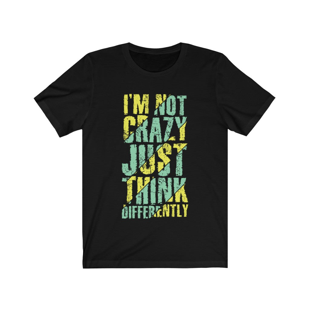 A unisex t-shirt featuring the phrase 'I am not Crazy Just Think Differently' in bold vinyl print, made from 100% soft cotton.