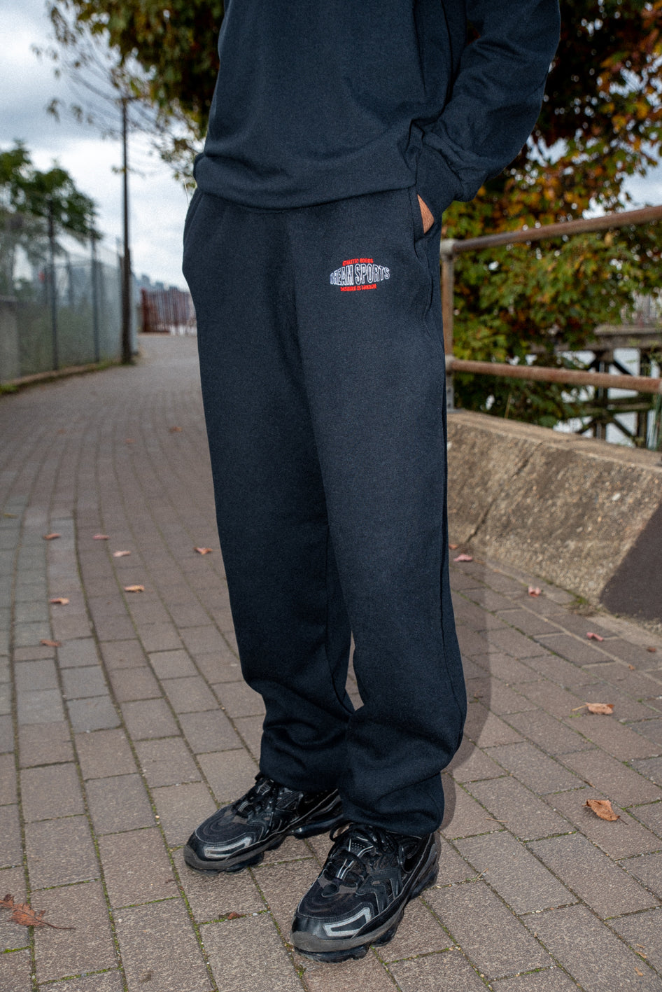 Black heavyweight joggers featuring Dream Sports embroidery, showcasing a relaxed fit and stylish design.