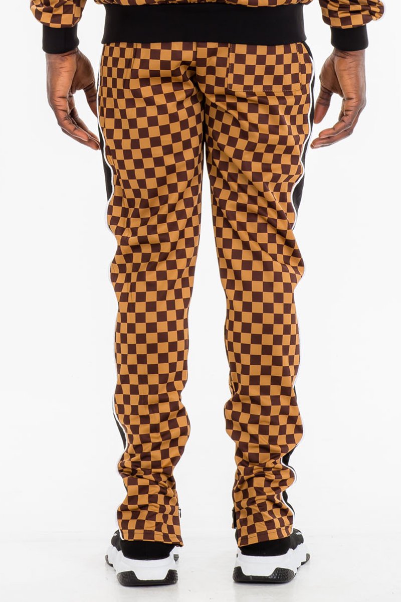 Jura Checkered Track Pants featuring a stylish checkered pattern, elastic waist with drawstring, and ankle zippers.