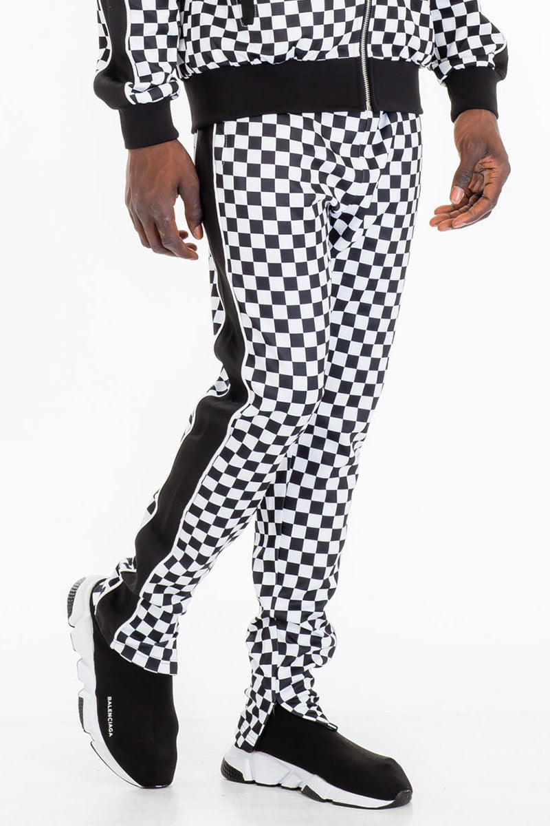 Jura Checkered Track Pants featuring a stylish checkered pattern, elastic waist with drawstring, and ankle zippers.