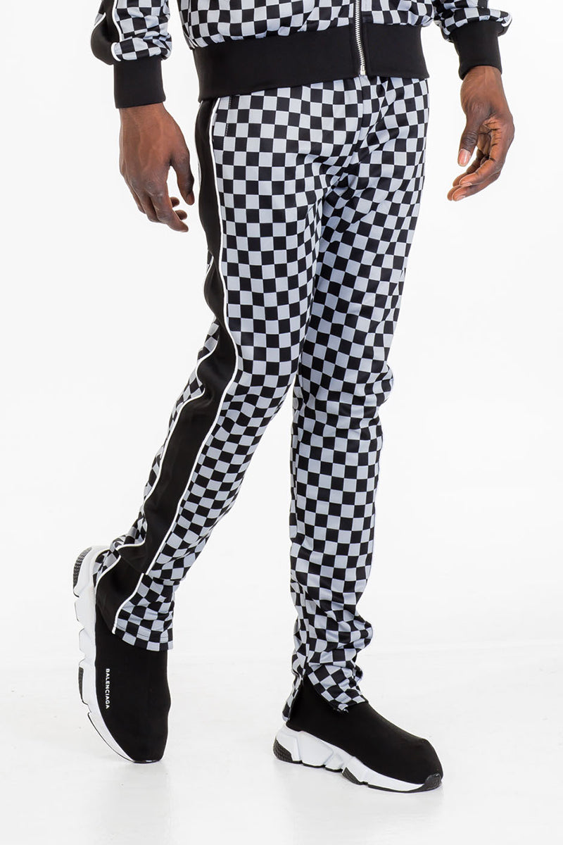 Jura Checkered Track Pants featuring a stylish checkered pattern, elastic waist with drawstring, and ankle zippers.