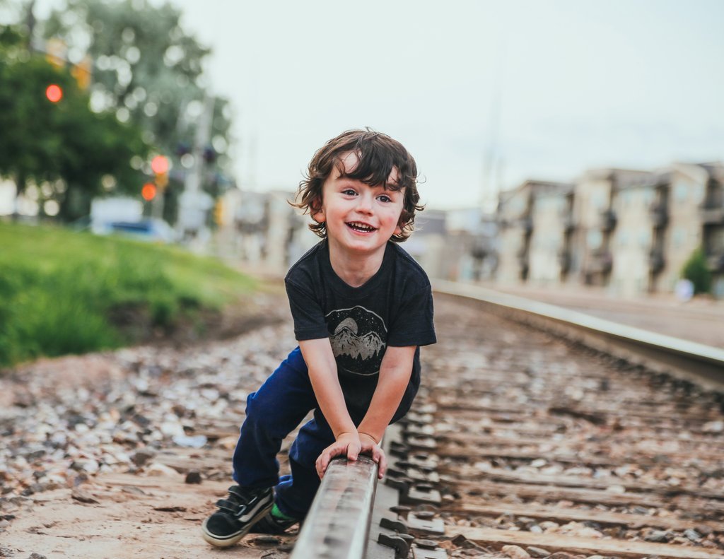 A soft gray kids graphic tee featuring a night sky design, perfect for adventurous children.