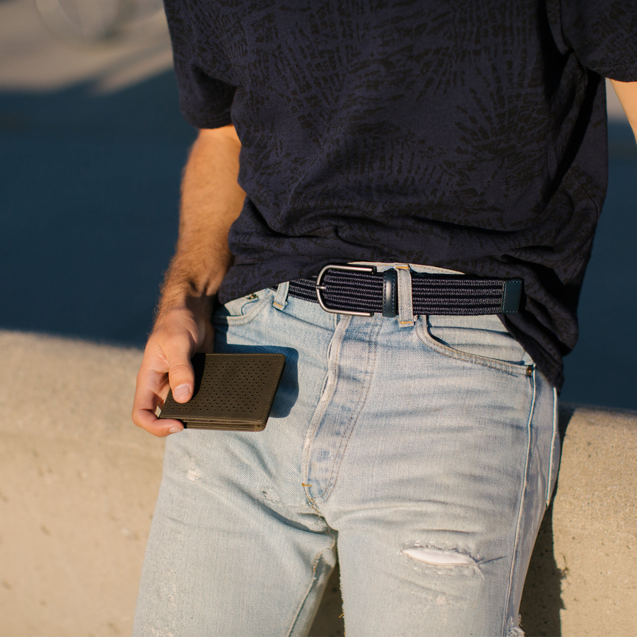 Kyle Leather Perforated Bifold Wallet in charcoal color, showcasing its stylish perforated design and compact size.