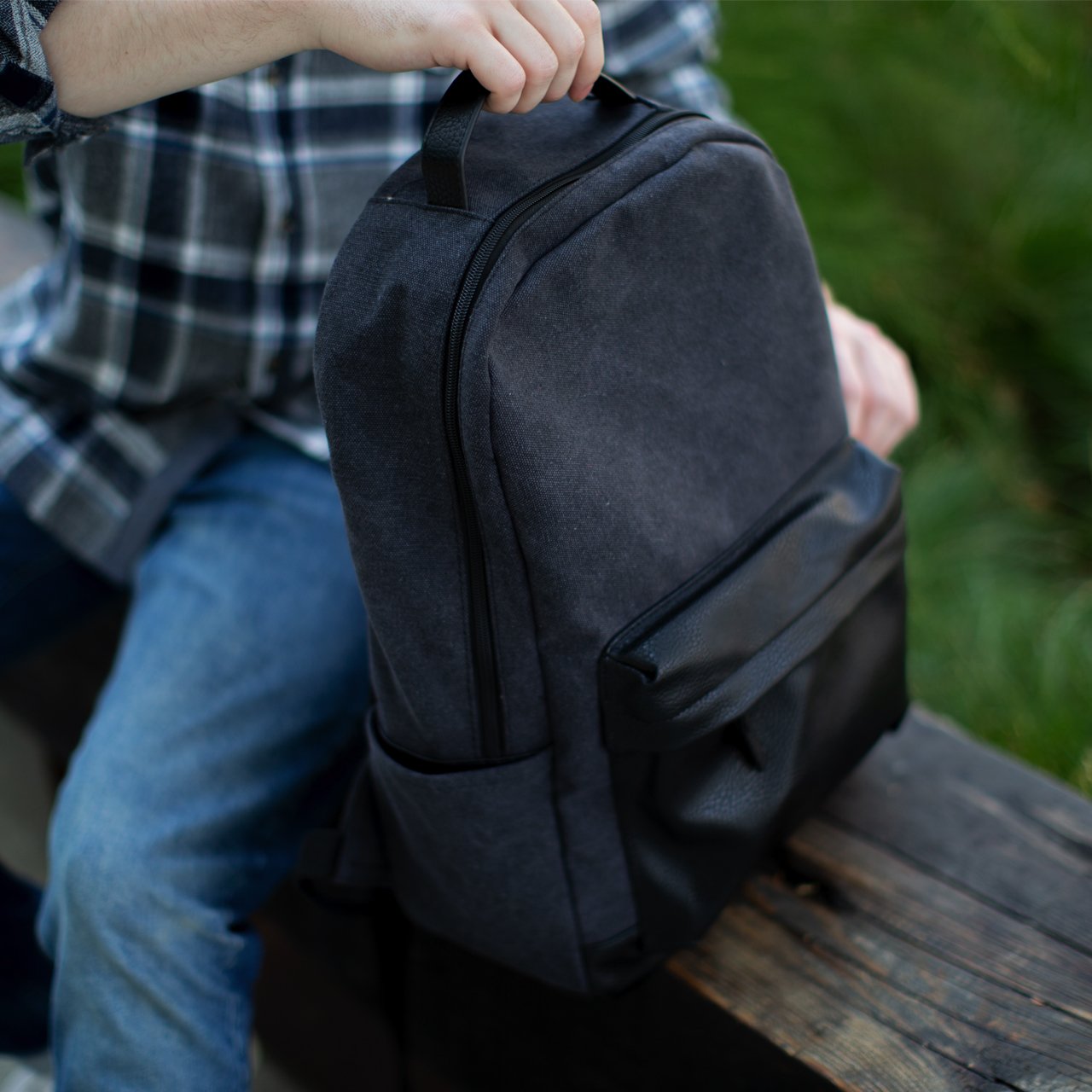 Landen Canvas Backpack featuring durable canvas material, vegan leather details, padded straps, and multiple pockets.