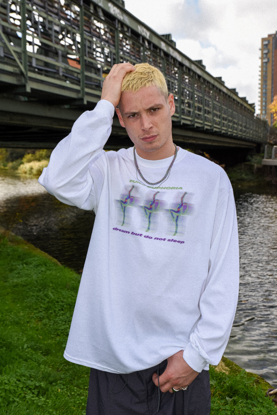 Long sleeved white cotton t-shirt featuring a vibrant Pure Euphoria print on the front, styled for an oversized look.