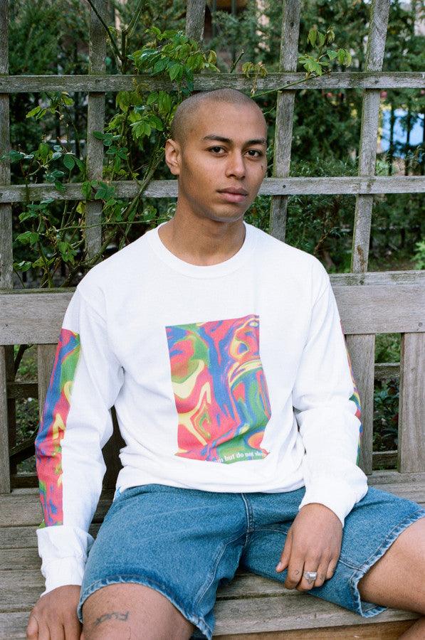 White long sleeved t-shirt featuring a vibrant trippy festival print on the front, back, and sleeves, made from soft cotton.