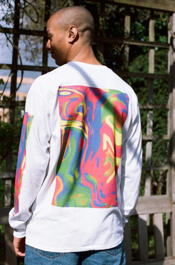 White long sleeved t-shirt featuring a vibrant trippy festival print on the front, back, and sleeves, made from soft cotton.