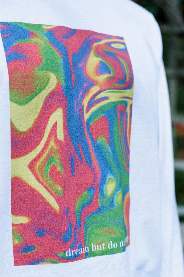 White long sleeved t-shirt featuring a vibrant trippy festival print on the front, back, and sleeves, made from soft cotton.