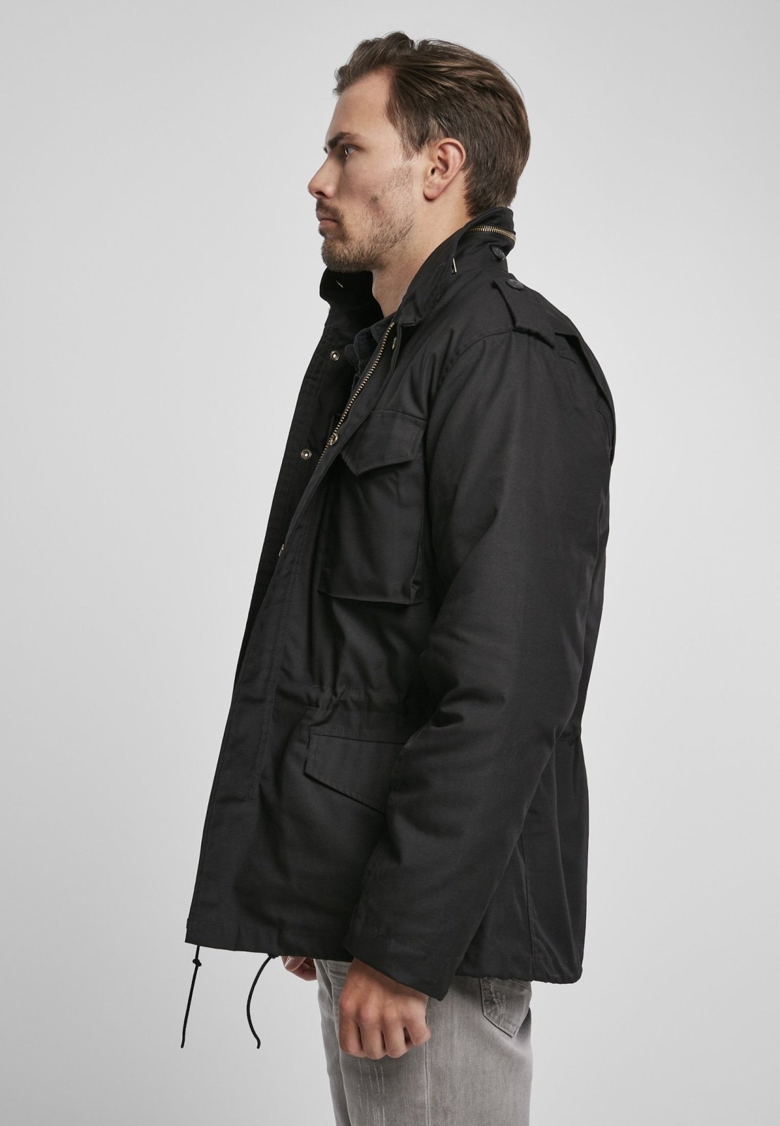 M65 Classic Jacket featuring a robust, water-repellent design with a removable inner jacket and hood in collar, perfect for urban adventures.