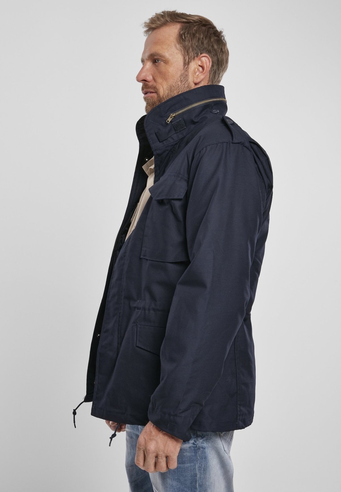 M65 Classic Jacket featuring a robust, water-repellent design with a removable inner jacket and hood in collar, perfect for urban adventures.