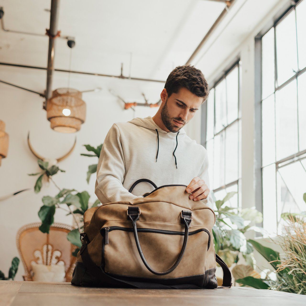 Marcel Two Tone Duffle Bag in stylish vegan leather with dual handles and adjustable strap.