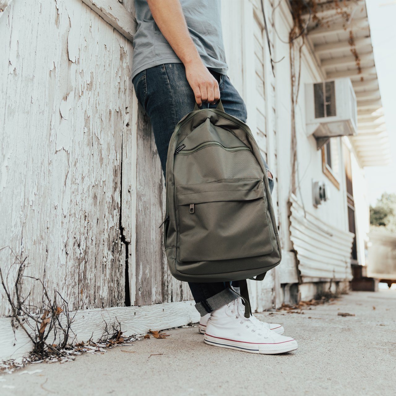 Mike Backpack in olive green with multiple pockets and padded straps, perfect for daily use.