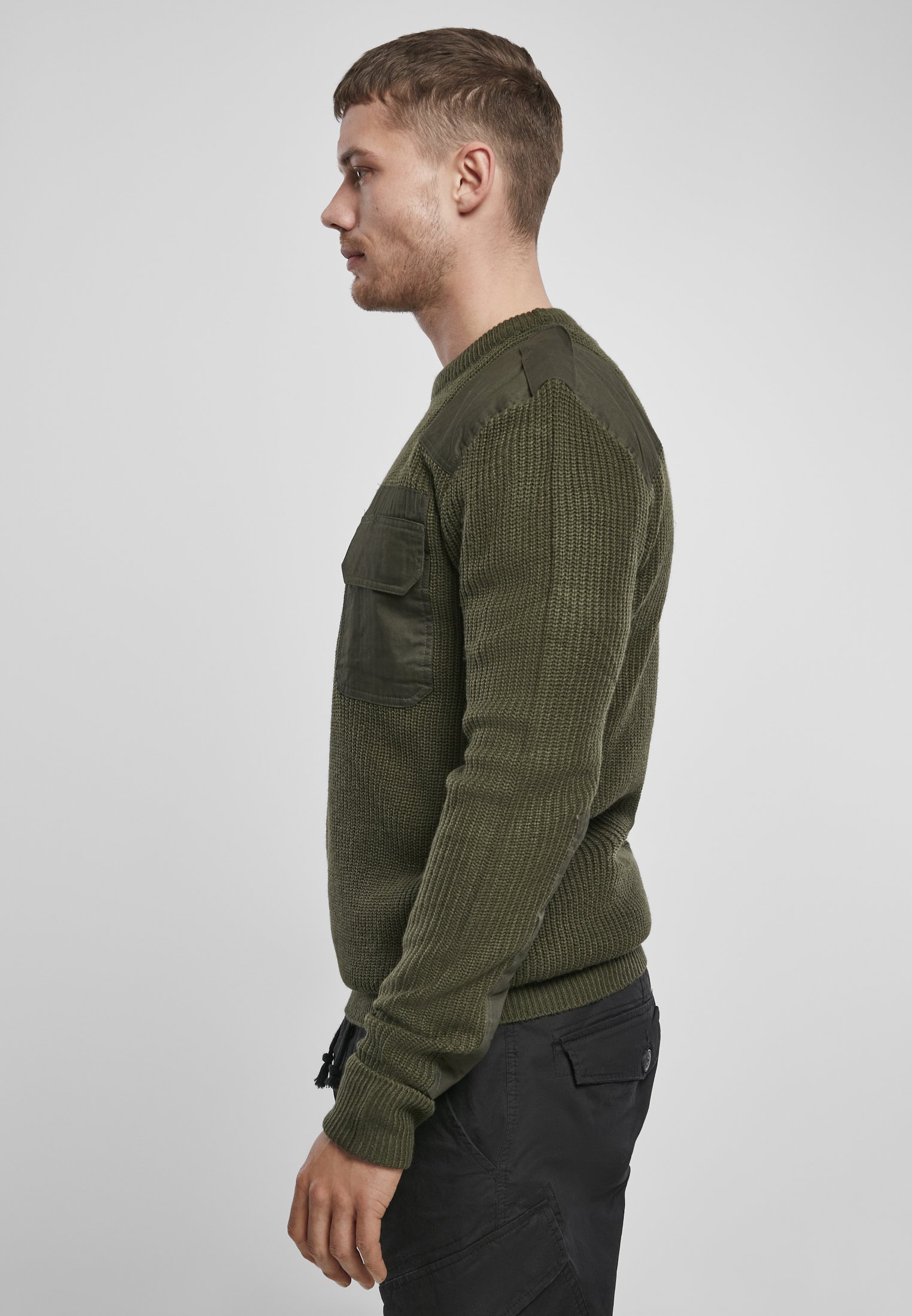 A durable Military Sweater featuring reinforced elbows and shoulders, epaulettes, and a patch chest pocket in muted colors.