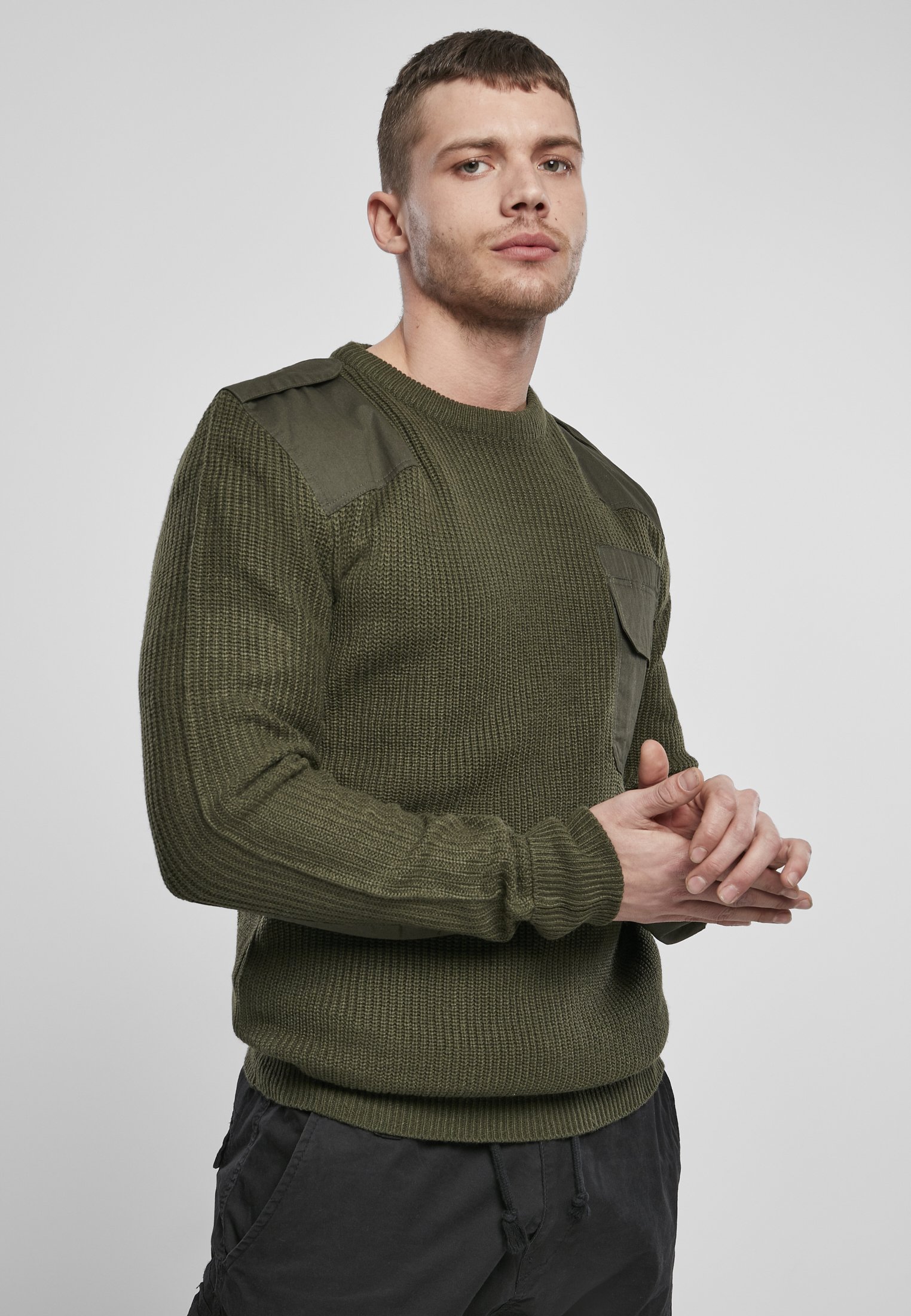 A durable Military Sweater featuring reinforced elbows and shoulders, epaulettes, and a patch chest pocket in muted colors.