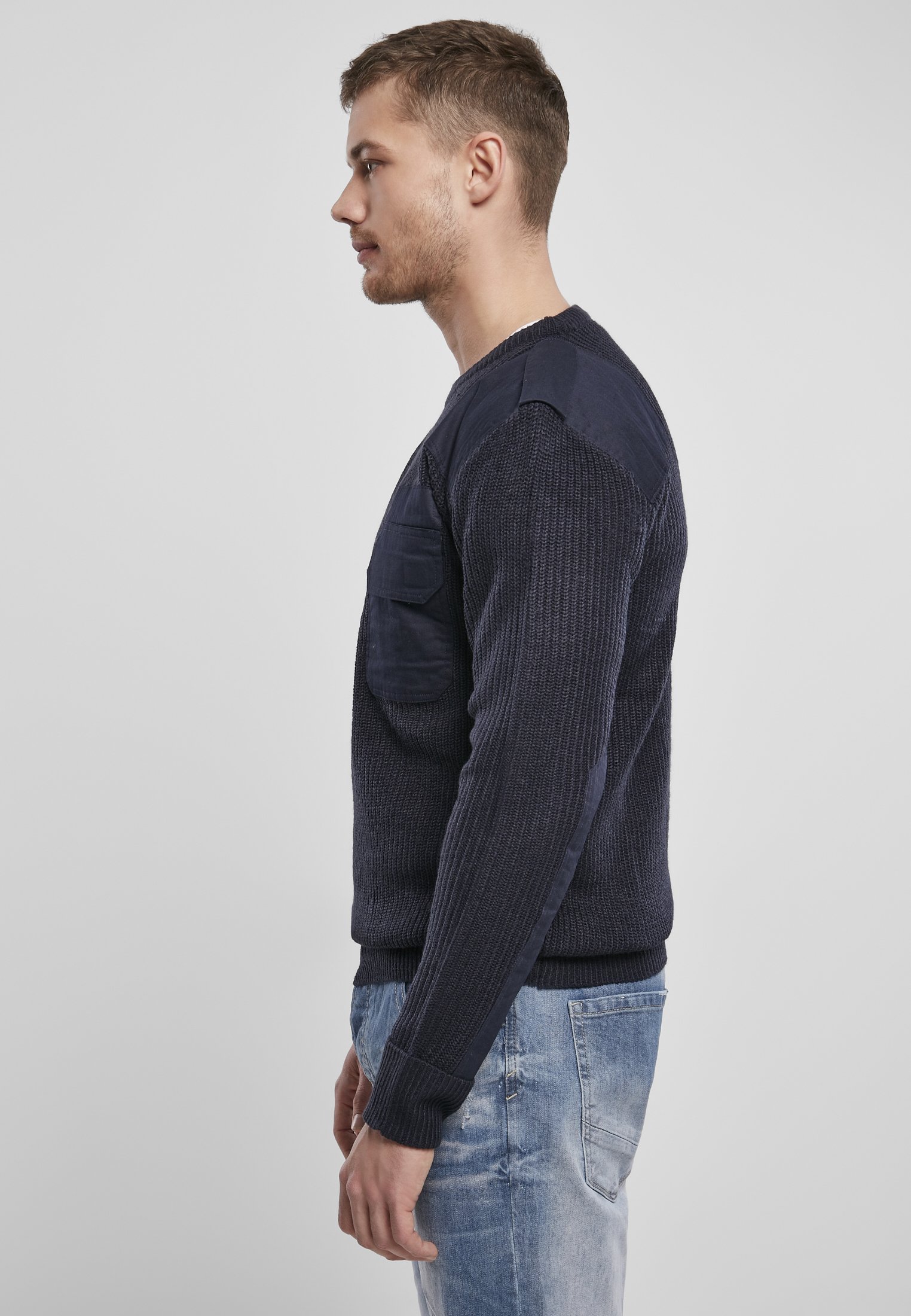 A durable Military Sweater featuring reinforced elbows and shoulders, epaulettes, and a patch chest pocket in muted colors.