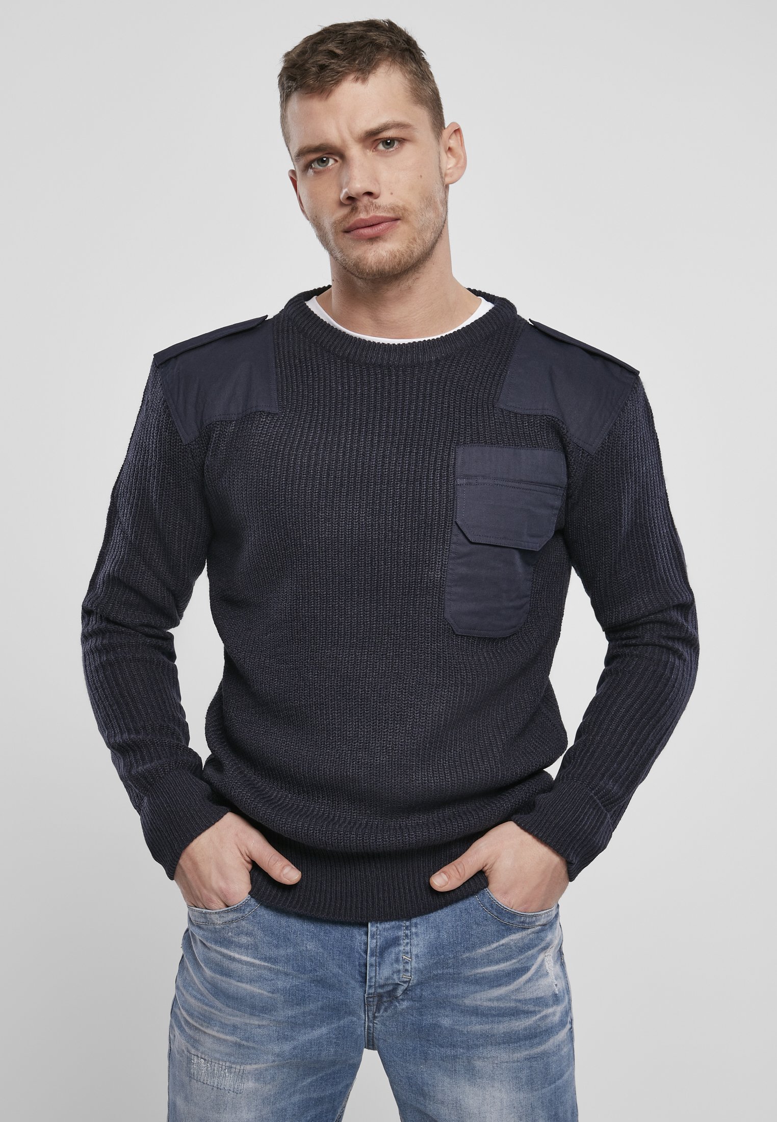 A durable Military Sweater featuring reinforced elbows and shoulders, epaulettes, and a patch chest pocket in muted colors.