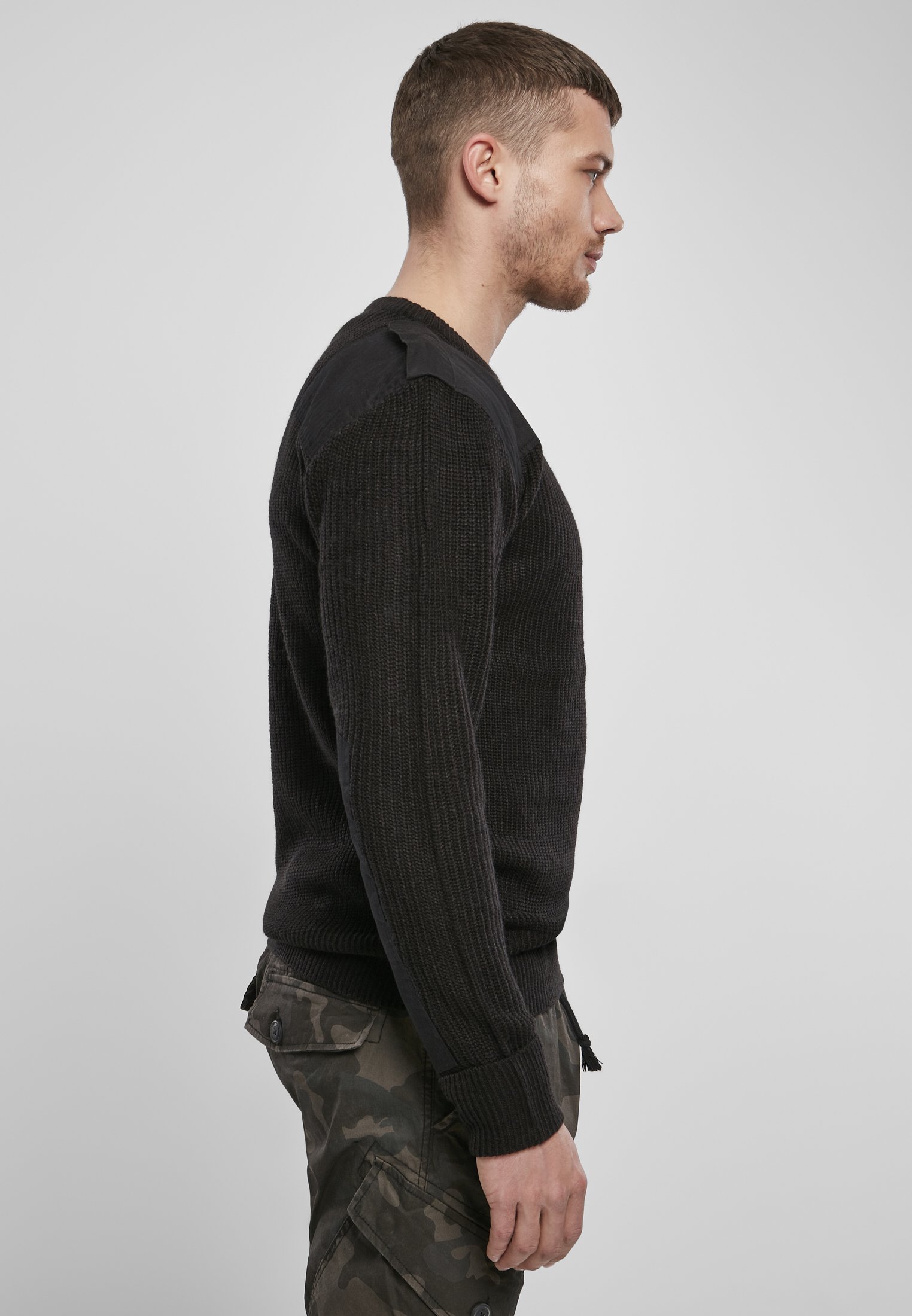 A durable Military Sweater featuring reinforced elbows and shoulders, epaulettes, and a patch chest pocket in muted colors.