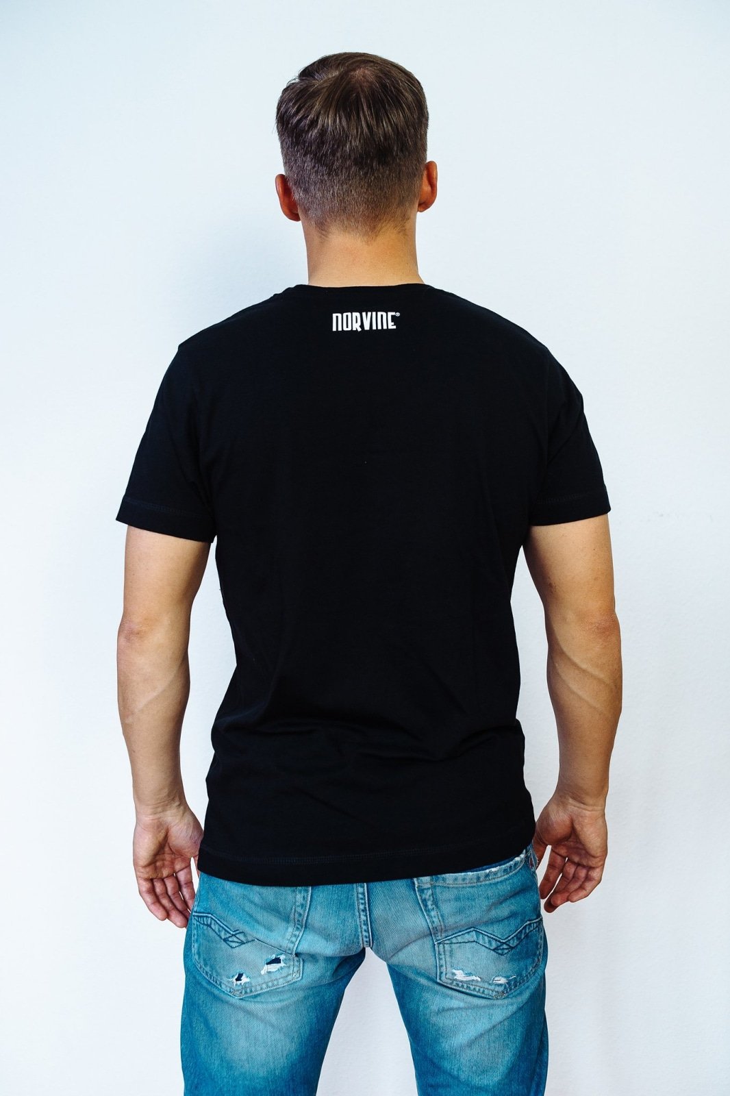 Two Minimal Organic T-Shirts in black and white, featuring the Norvine logo on the back, made from 100% organic combed cotton.