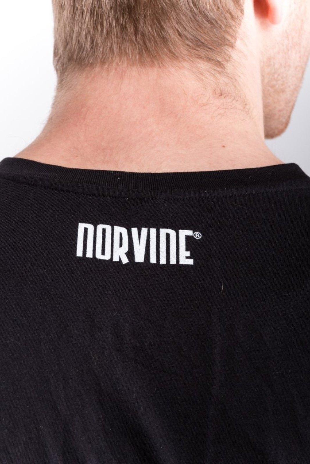 Two Minimal Organic T-Shirts in black and white, featuring the Norvine logo on the back, made from 100% organic combed cotton.