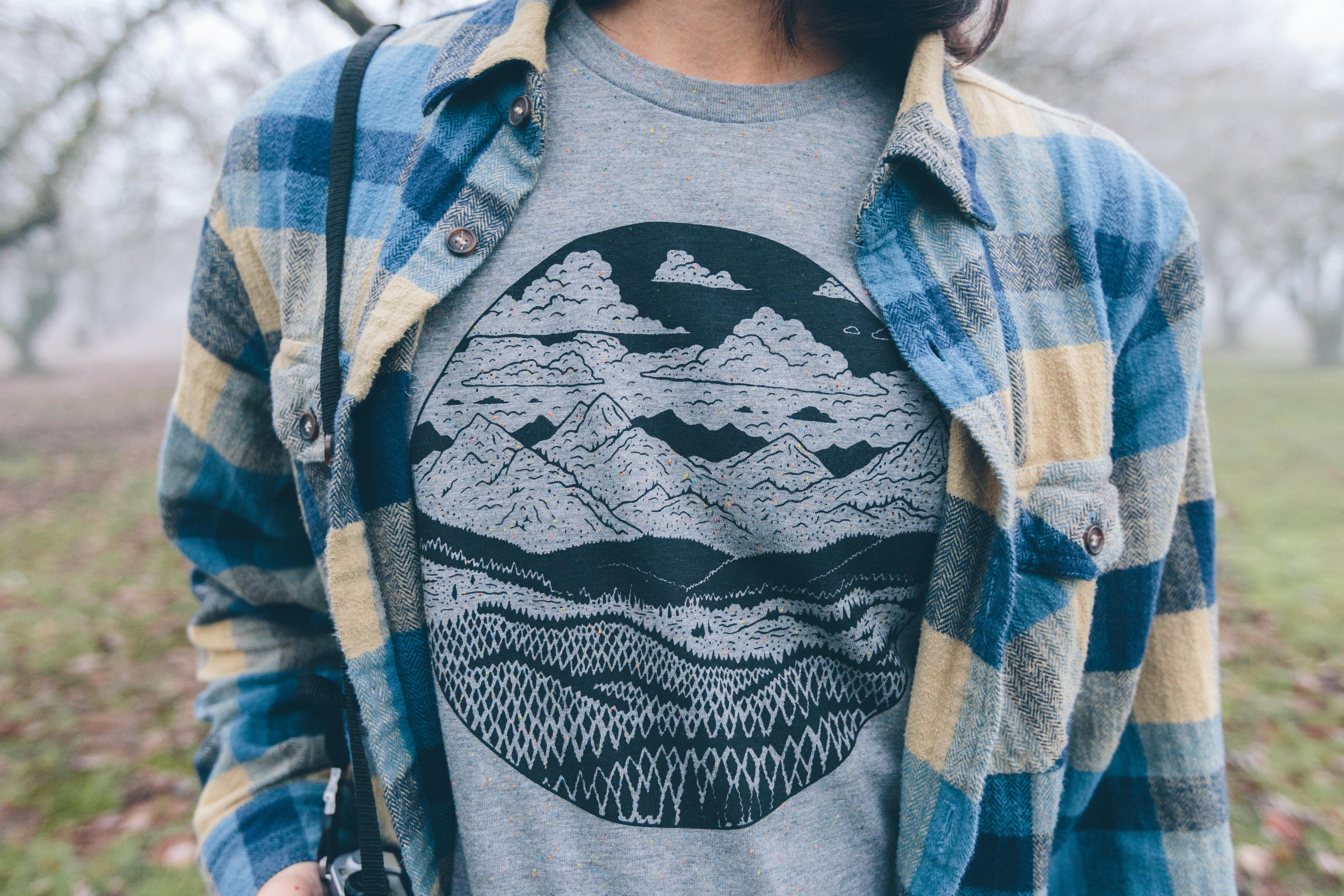 Gray speckled Mountain Range Tee featuring a unique mountain design printed in black water-based ink.