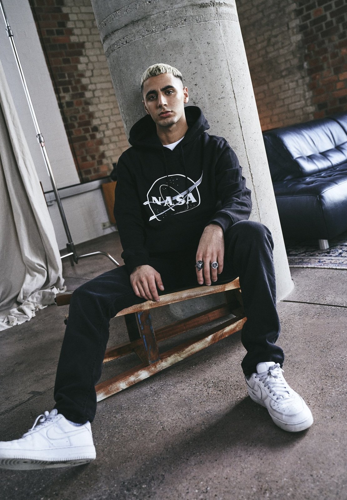 A stylish black hoodie featuring the iconic NASA insignia in white, perfect for space enthusiasts.