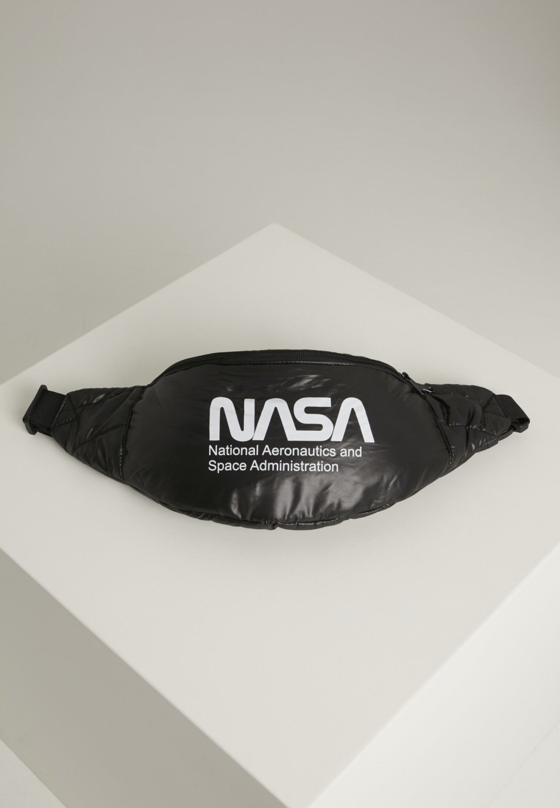 Stylish NASA Hip Bag with glossy quilted material and adjustable strap, featuring the iconic NASA emblem.