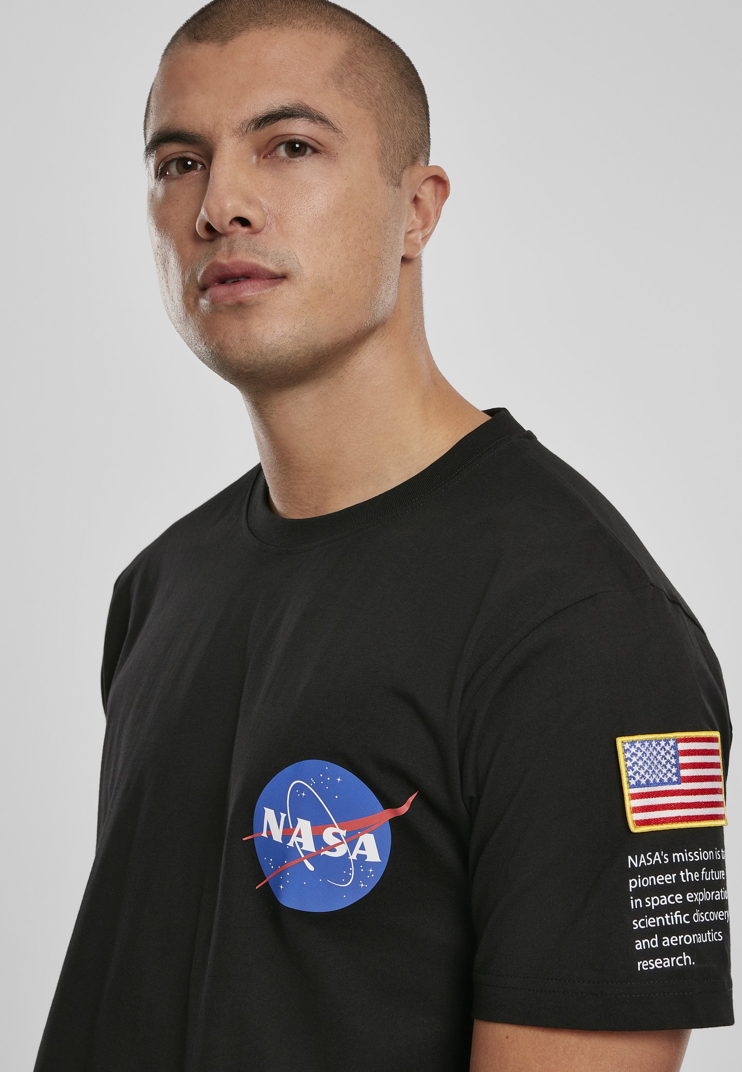 NASA Insignia Logo Flag Tee made of 100% cotton, featuring the iconic NASA logo in vibrant colors.