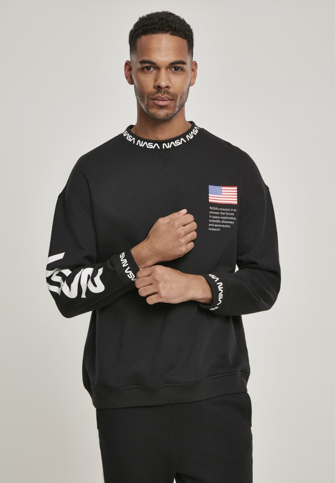 A cozy NASA Oversize Crewneck Sweater featuring logos on the sleeve and chest, perfect for space enthusiasts.