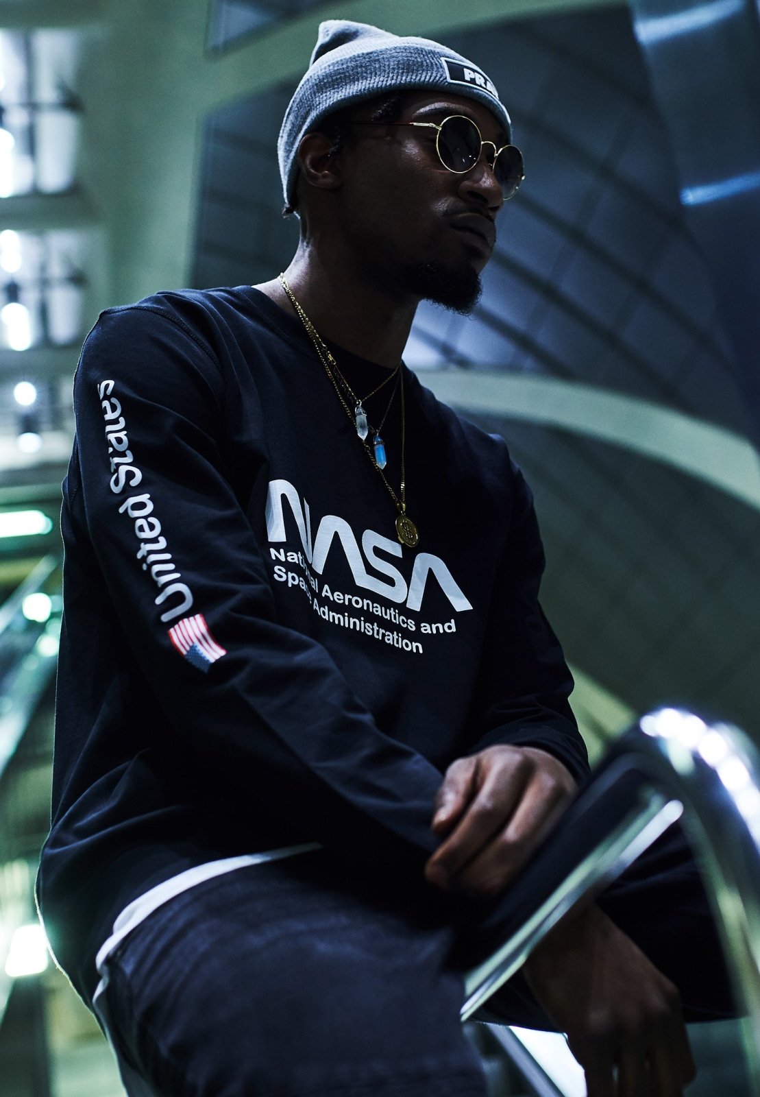 NASA United States Longsleeve crewneck shirt featuring a meaningful front and sleeve print, made from 100% cotton for comfort.