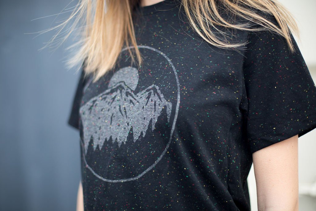 Night Sky Tee in speckled black with gray ink, showcasing a starry design, perfect for outdoor enthusiasts.